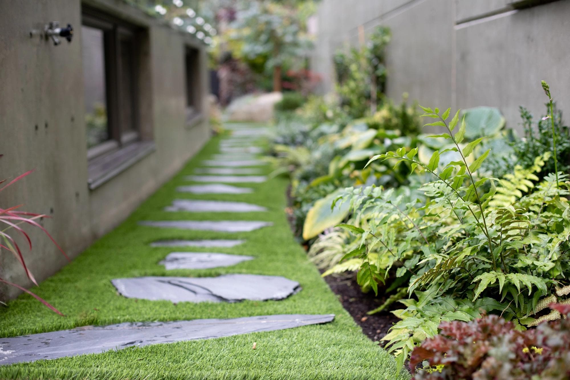 A lush and vibrant garden framed by stone walls.